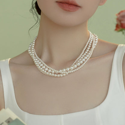 The star wears the same style in multiple layers, one  pearl necklace, and wears more strong lights to send to ladies